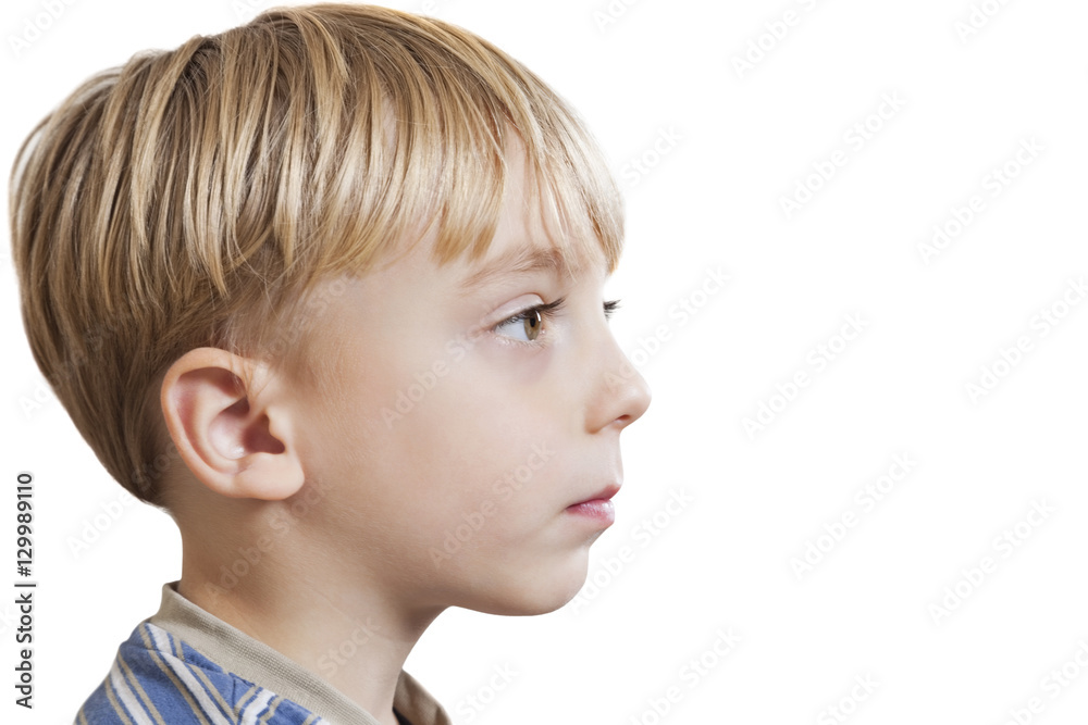 Close-up of young boy looking at copy space over white background Close-up of young boy looking at copy space over white background