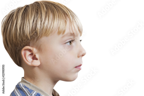 Close-up of young boy looking at copy space over white background