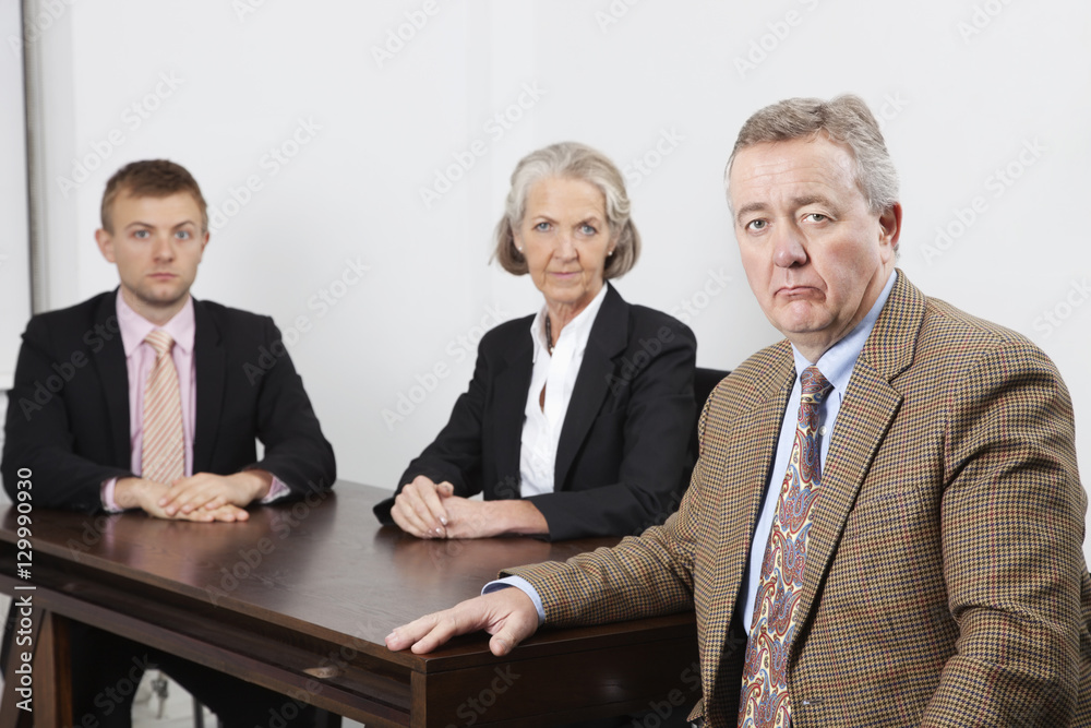 Fototapeta premium Portrait of confident business group at desk in office