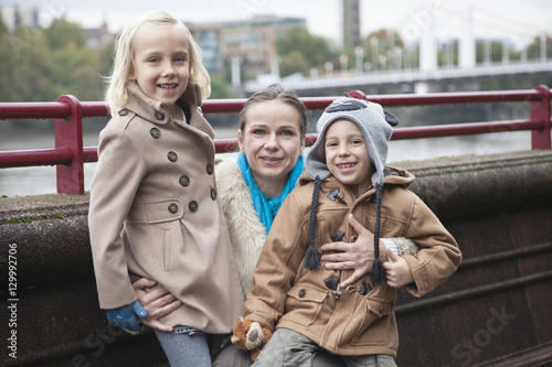 Portrait of young woman with children smiling outdoors photo