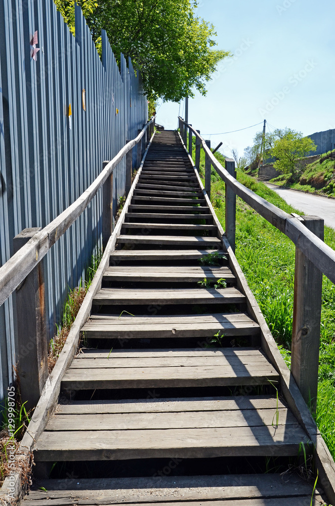 Fototapeta premium Long wooden stairs in the city