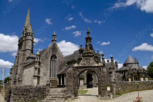 Triumphal Arch dating from between 1581 and 1588, and church dating from the 16th and 17th centuries, Guimiliau parish enclosure, Finistere, Brittany, France photo