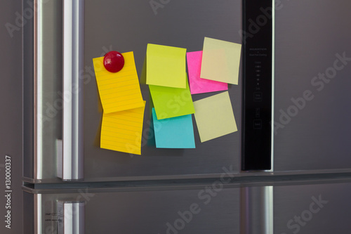 Abstract of Blank paper and post-it on refrigerator door.