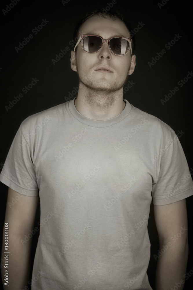 Portrait of handsome young man wearing sunglasses on black background Portrait of handsome young man wearing sunglasses on black background