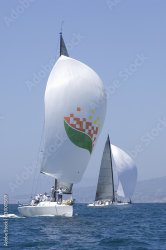 View of two yachts compete in team sailing event