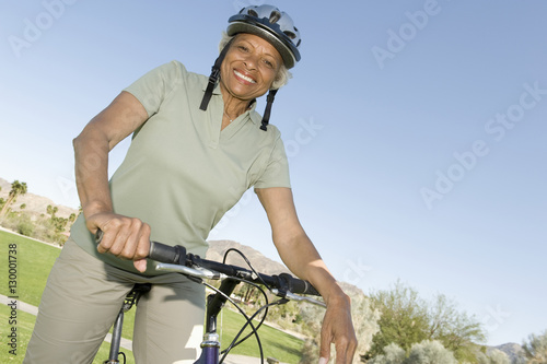 Portrait of a happy African American senior woman with mountain bike