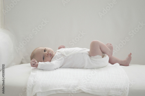 Full length of two weeks old newborn baby lying o sofa