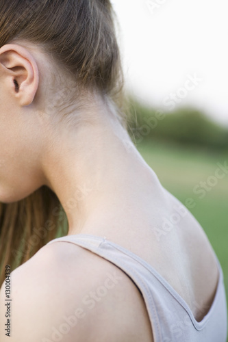 Closeup side view of a cropped woman's neck against blurred background