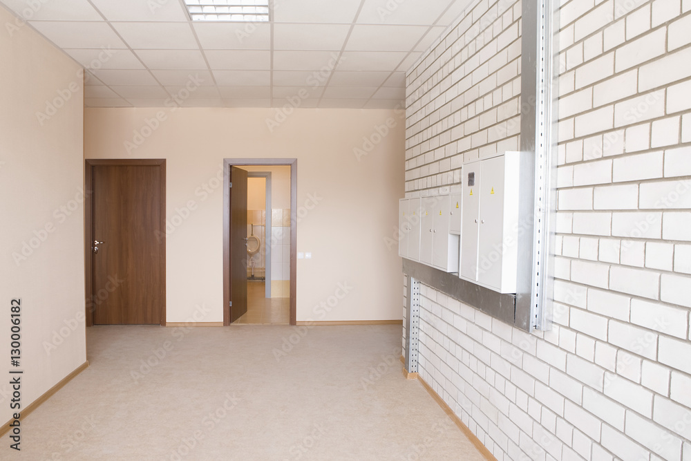 Tiled wall with fusebox in wide hallway Tiled wall with fusebox in wide hallway