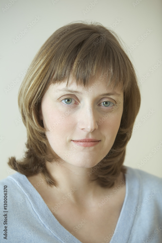 Portrait of beautiful young woman against gray background Portrait of beautiful young woman against gray background