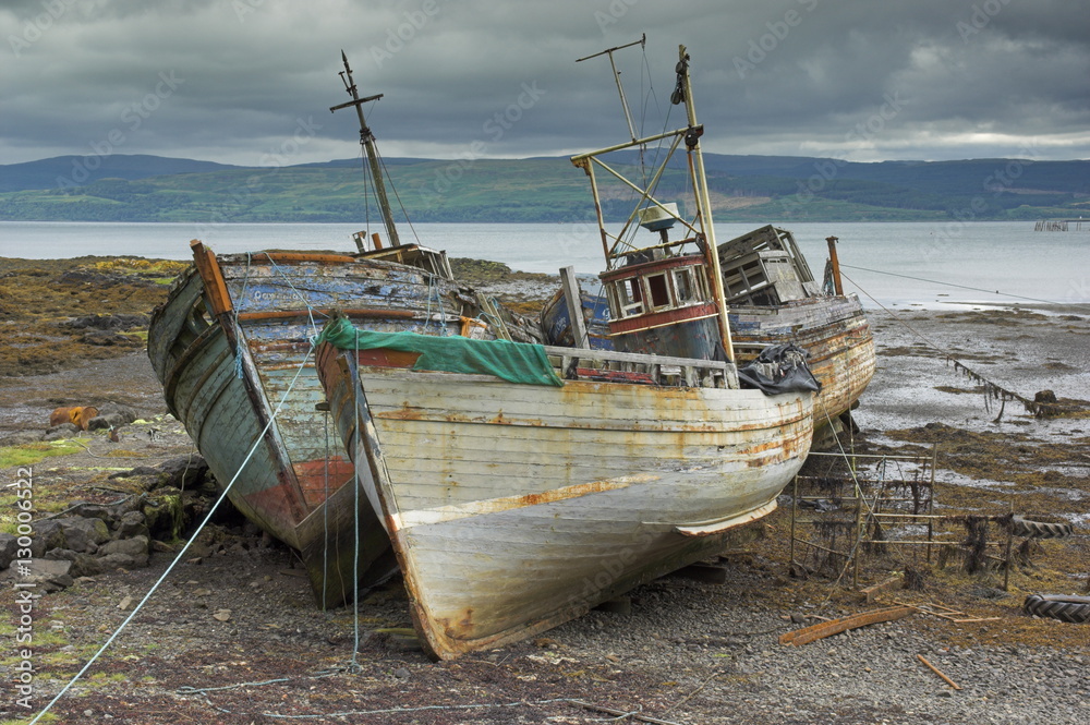 Wrecked fishing boats in gathering storm, Salen, Isle of Mull, Inner Hebrides, Scotland Wrecked fishing boats in gathering storm, Salen, Isle of Mull, Inner Hebrides, Scotland