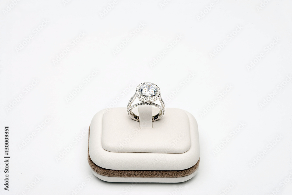 Platinum ring with 5 carat centre diamond surrounded by full cut 0.80 carat diamonds over white background
