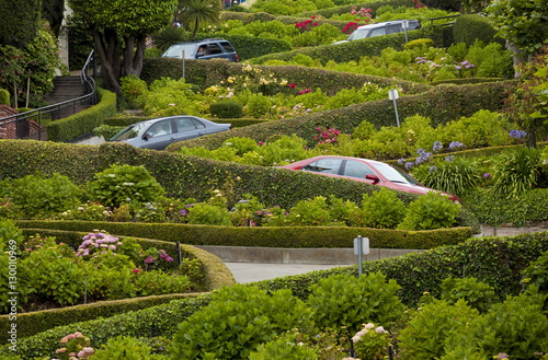 Traffic slowly zigzags down Lombard Street, the crookedest street in the city, San Francisco, California photo