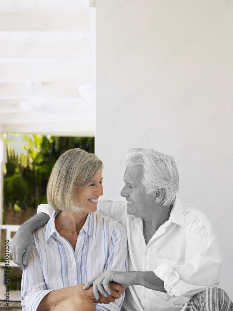 Happy senior man looking at middle-aged woman Happy senior man looking at middle-aged woman