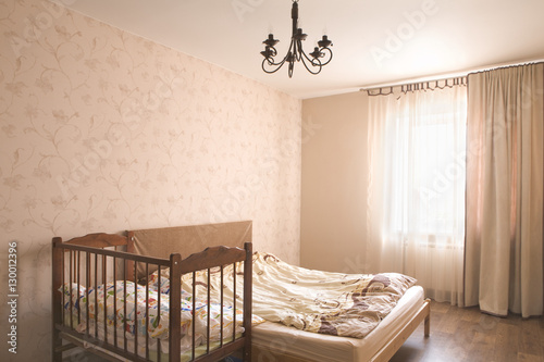 Interior of empty bedroom with crib