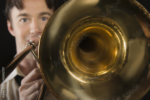 Closeup of a trombone while man playing it