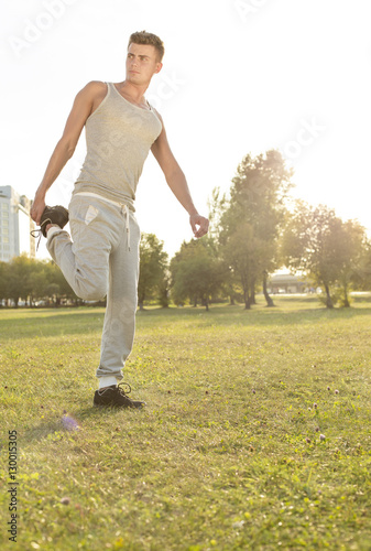 Full length of young man exercising in park