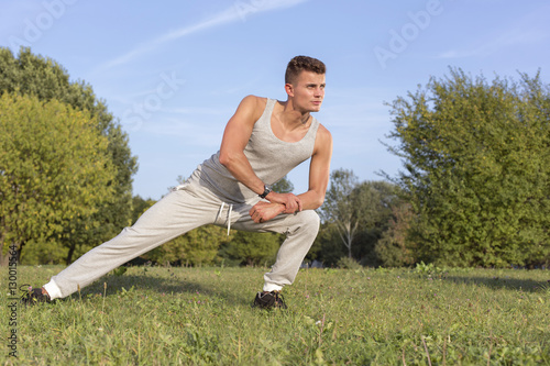 Full length of confident man exercising in park