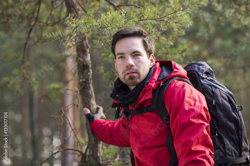 Young male backpacker in forest