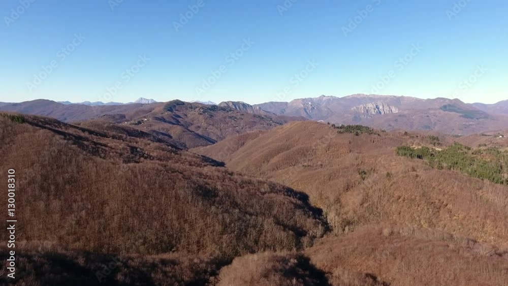 Aerial shot, autumn wood in the mountains with orange dry leaves, sun high in the sky, filmed with drone Aerial shot, autumn wood in the mountains with orange dry leaves, sun high in the sky, filmed with drone