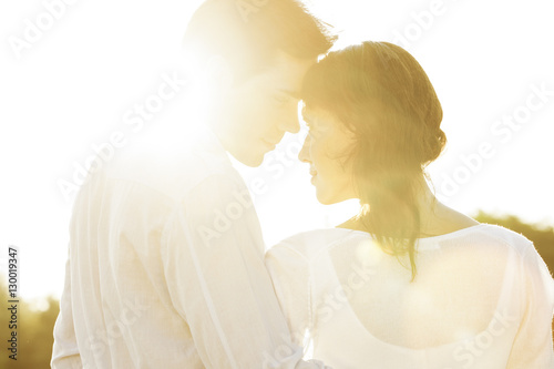 Rear view of romantic couple looking at each other during summer