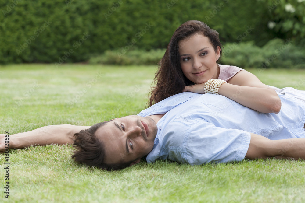 Loving young couple relaxing in park Loving young couple relaxing in park
