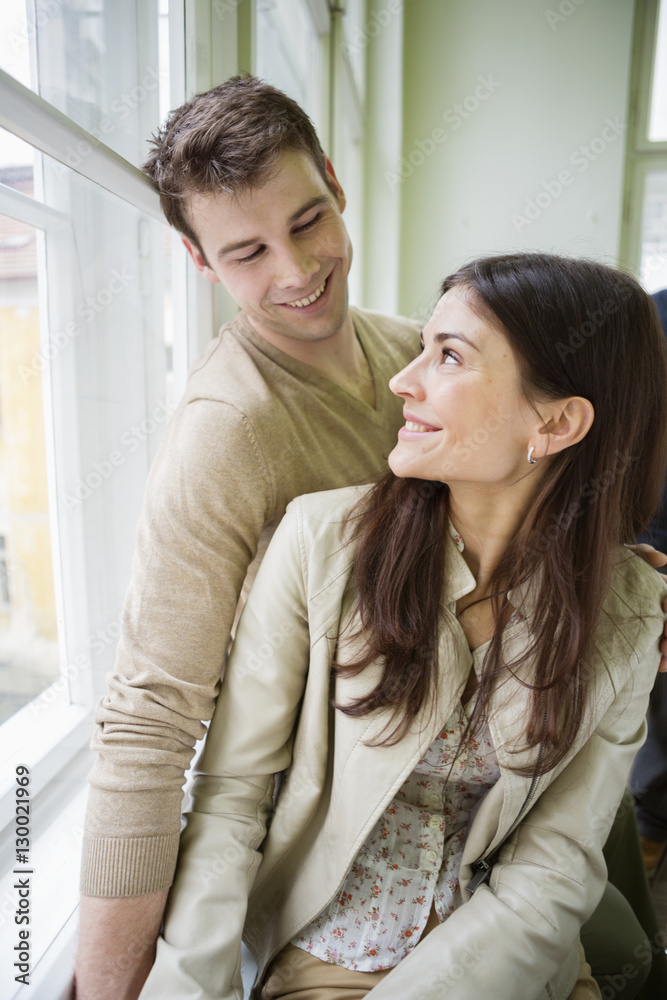Obraz premium Happy romantic couple looking at each other at home