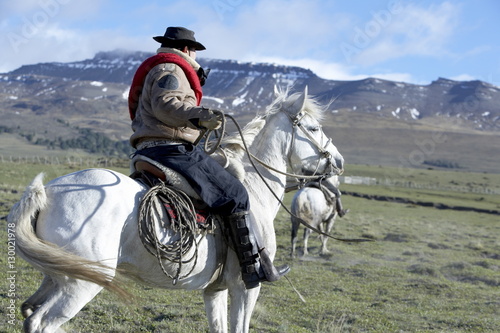 A gaucho riding his horse, Torres del Paine National Park, Patagonian Andes, Patagonia, Chile photo