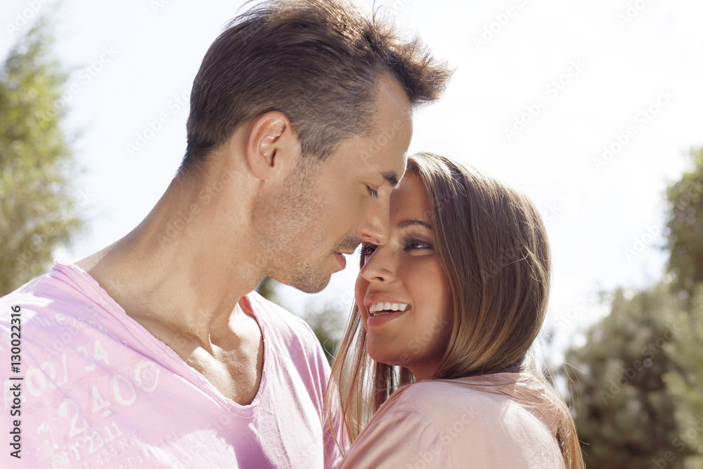 Loving young couple embracing in park Loving young couple embracing in park