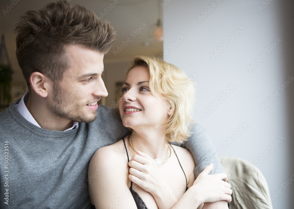 Happy young couple looking at each other in cafe Happy young couple looking at each other in cafe