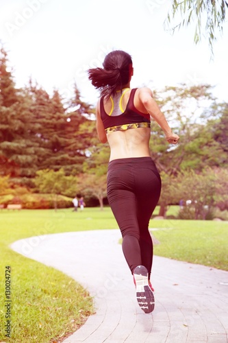 Rear view of woman running in park