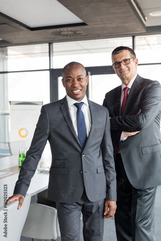Portrait of confident businessmen standing together in office Portrait of confident businessmen standing together in office