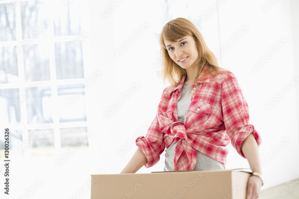 Portrait of beautiful woman carrying cardboard box Portrait of beautiful woman carrying cardboard box