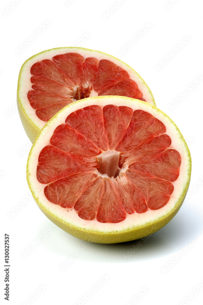 Halved grapefruit on white background