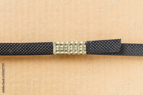 Plastic poly strap with metal clamp