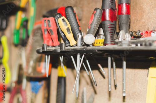 Car Repair Tools. different old tools hanging on wooden wall.
