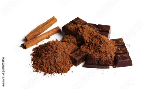 chocolate bars with cinnamon sticks and pile cocoa powder isolated on white background