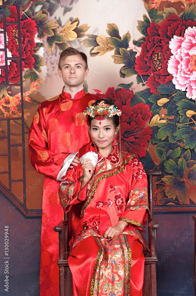 Mixed Race Bride and Groom in Studio wearing traditional Chinese wedding outfits