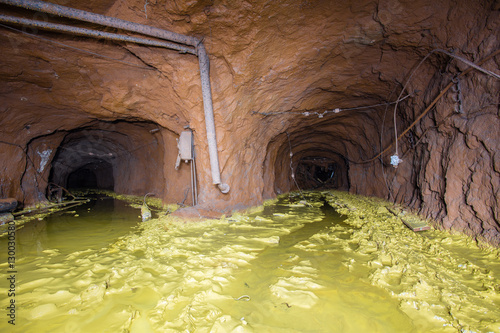 Abandoned mine tunnel shaft wit yellow dirt photo