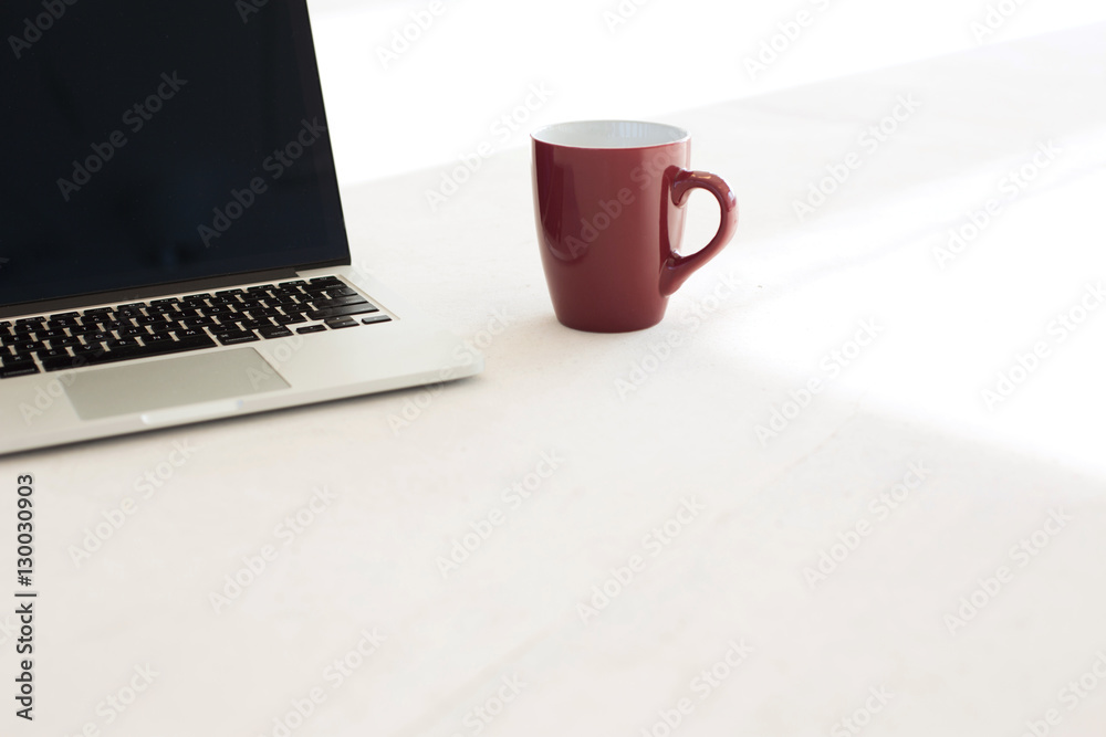 Laptop and coffee cup on floor of office Laptop and coffee cup on floor of office
