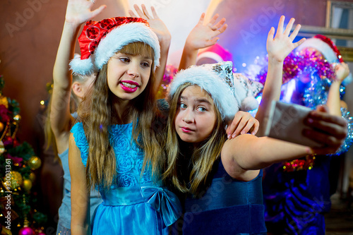 Group of cheerful young girls celebrating Christmas. Selfie