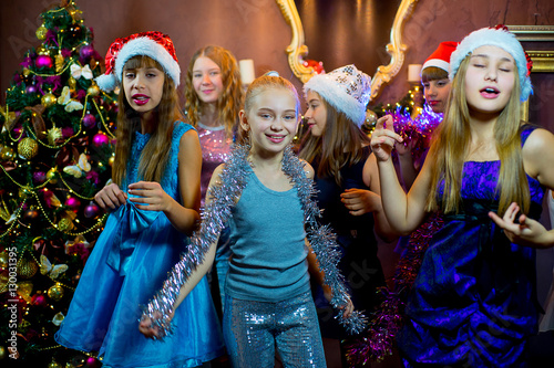 Group of cheerful young girls celebrating Christmas