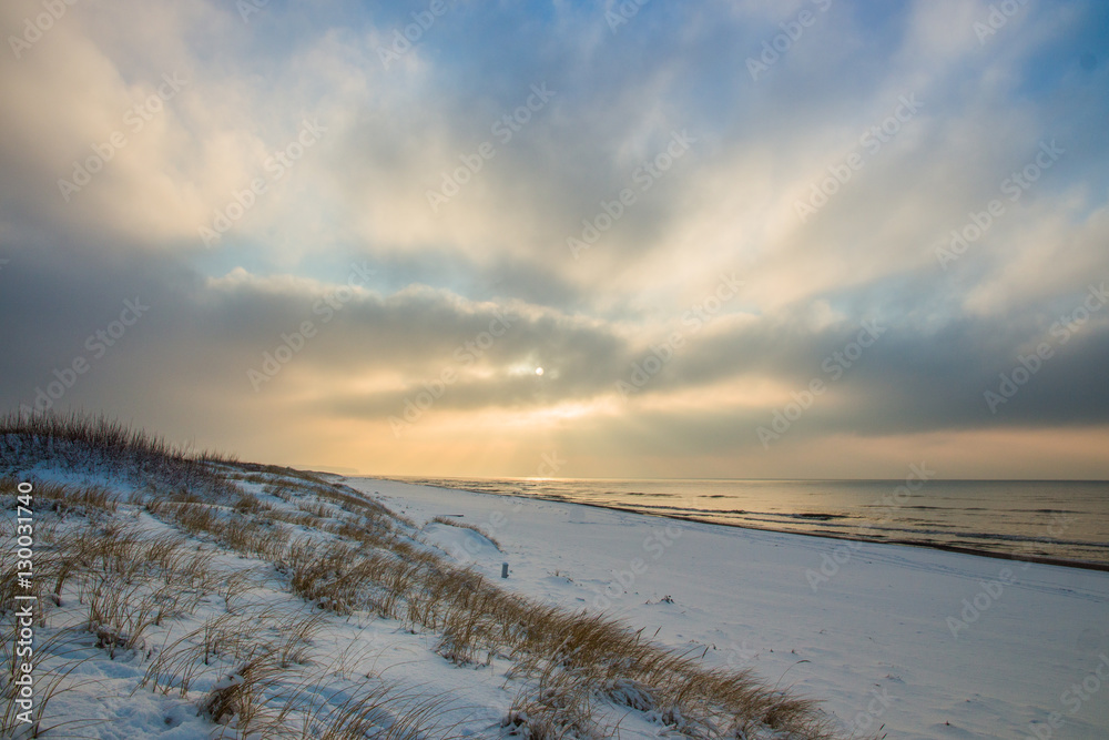 The rays of the sun in snowy beach,rural landscape The rays of the sun in snowy beach,rural landscape