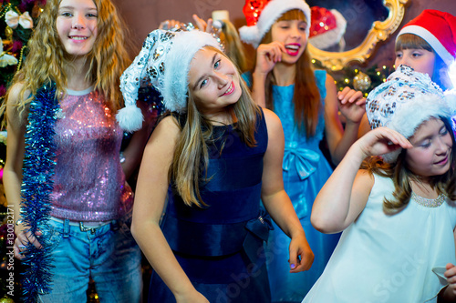 Group of cheerful young girls celebrating Christmas