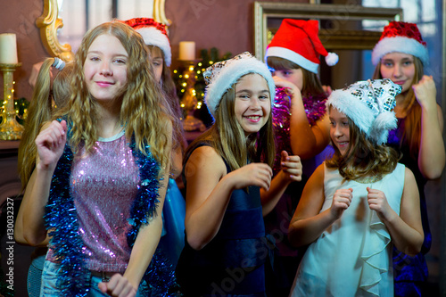 Group of cheerful young girls celebrating Christmas