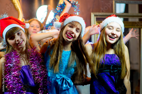 Group of cheerful young girls celebrating Christmas
