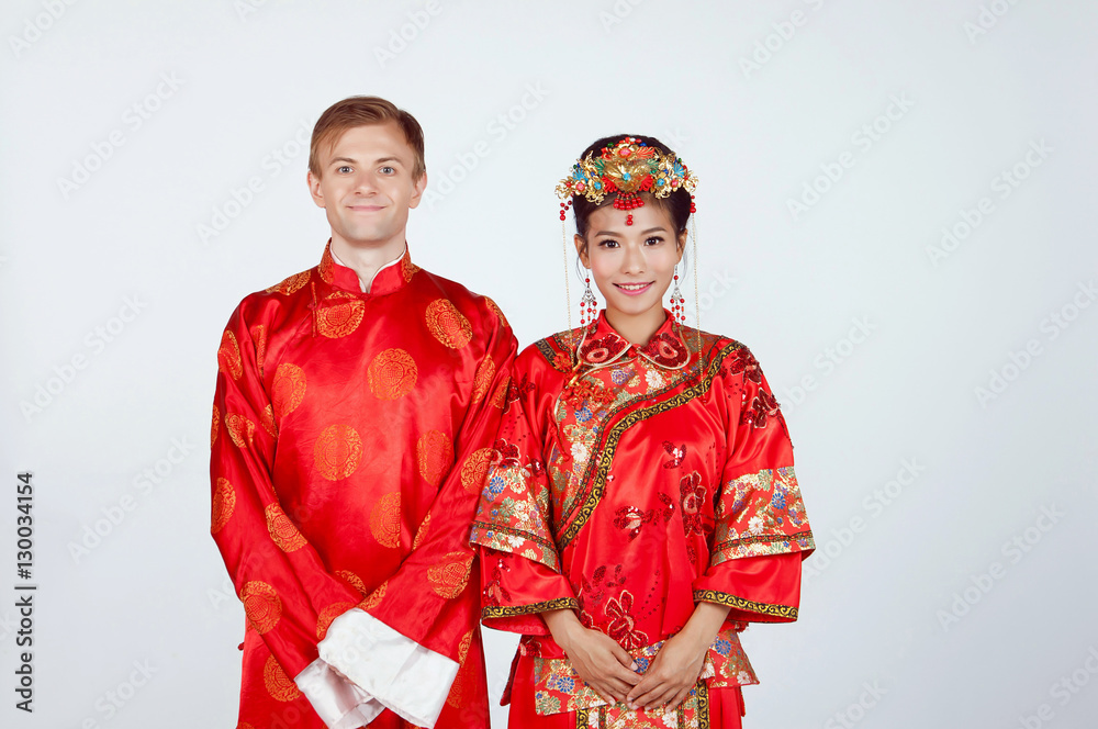 Mixed Race Bride and Groom in Studio wearing traditional Chinese wedding outfits