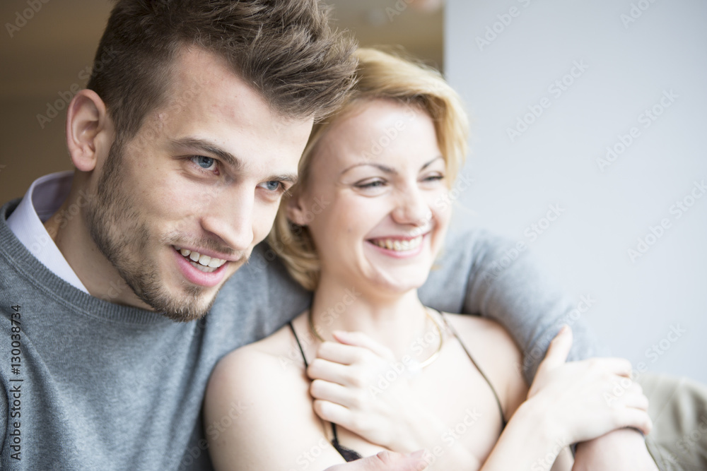 Happy young couple looking away in cafe