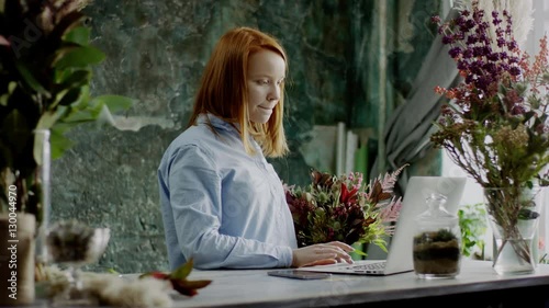 florist typing on laptop