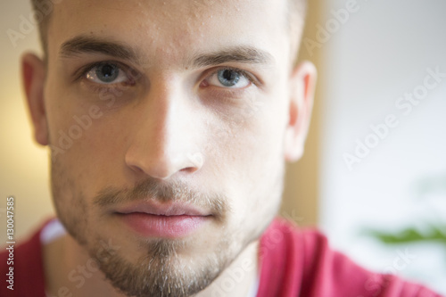 Close-up portrait of confident man in cafe